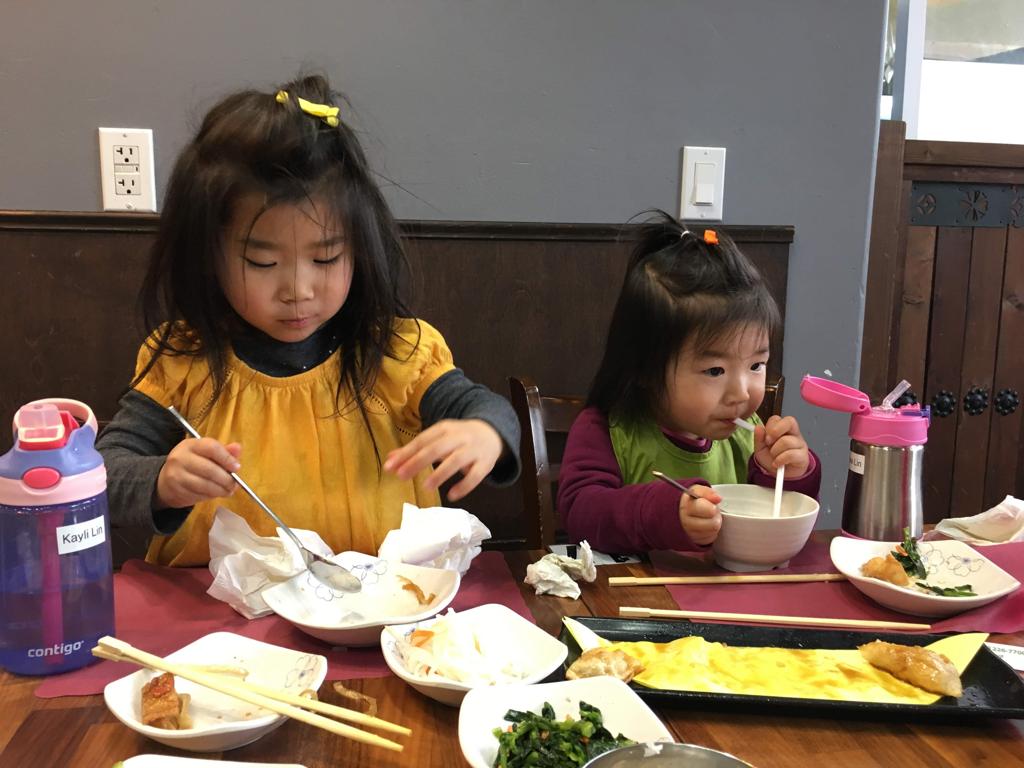 We love Korean food: fish cake, japchae, kalbi, and Meimei is drinking some gukmandu with a straw!