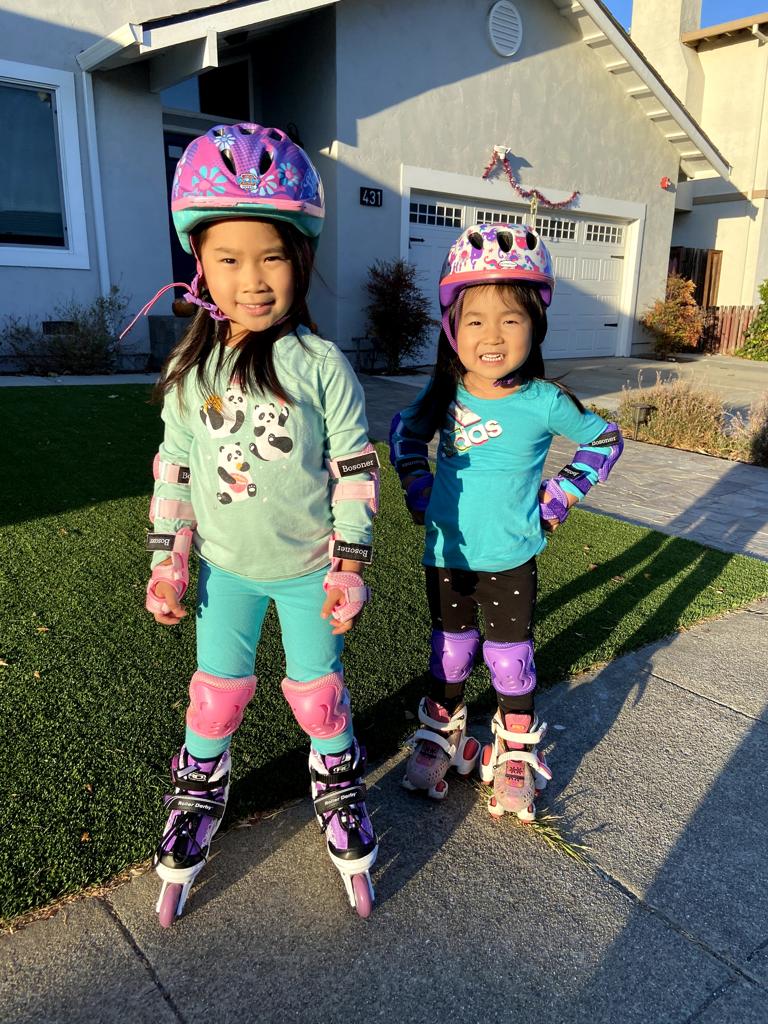 Kayli has purple rollerblades with pink pads. Meimei has pink rollerskates with purple pads. We look good!