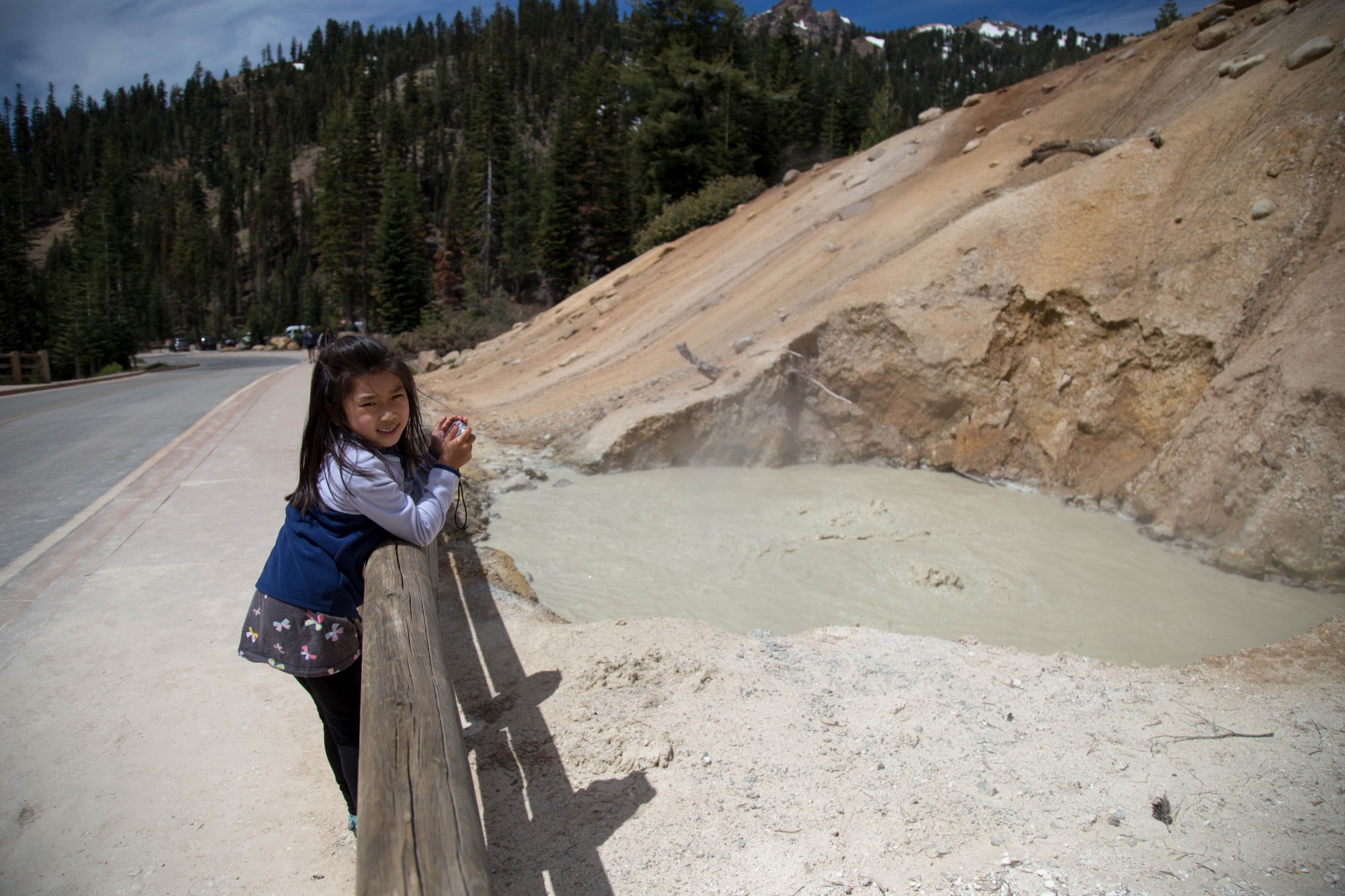 Our first stop was Lassen Volcanic National Park. It's the worst park ever. There is no playground and it stinks. Here is Kayli with some cool bubbling water, but not happy because it is stinky water.